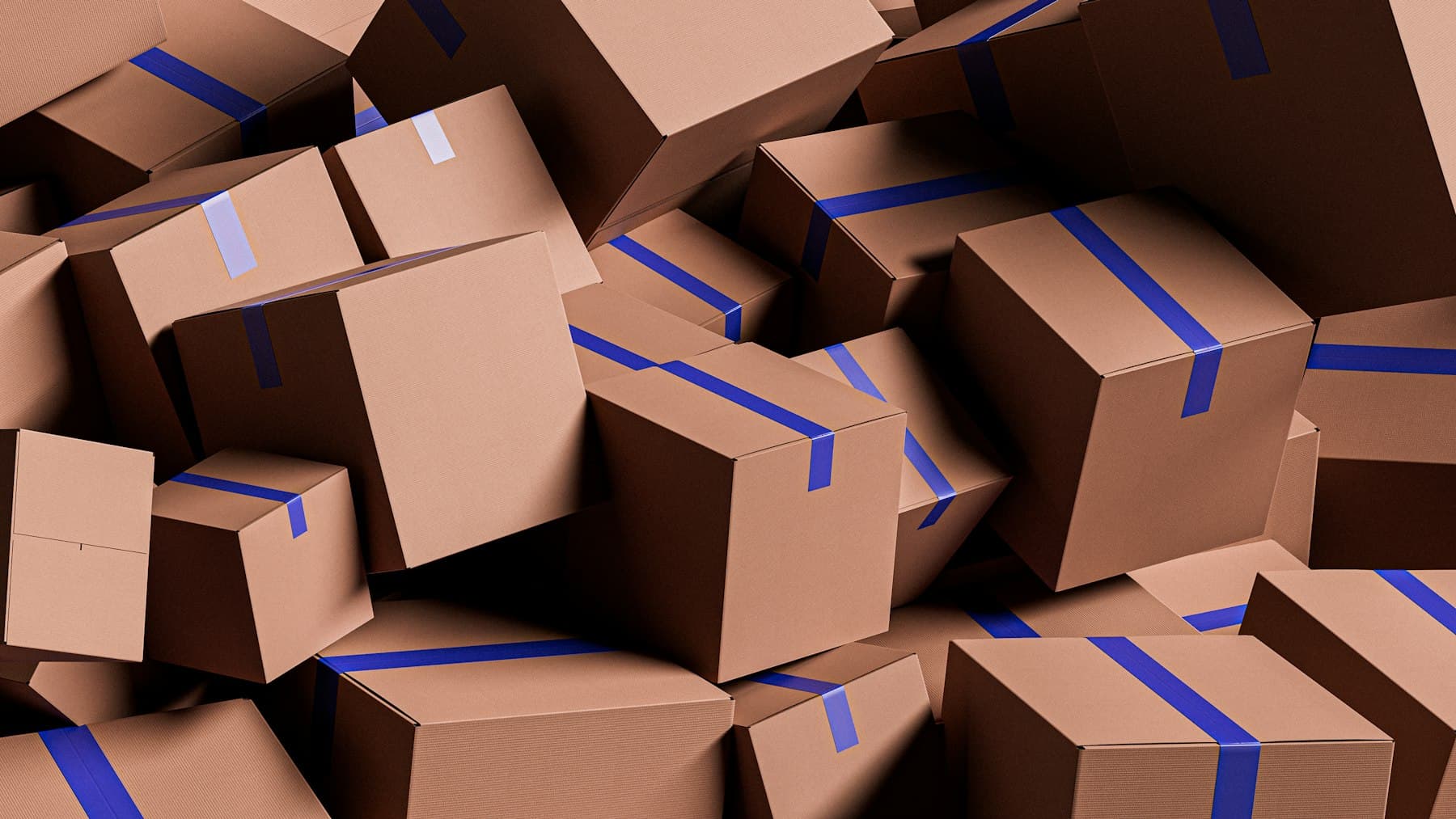 A pile of cardboard parcels sealed with blue tape
